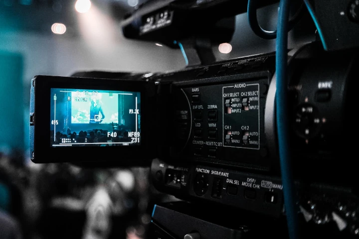 A video camera with the screen showing a man on it.